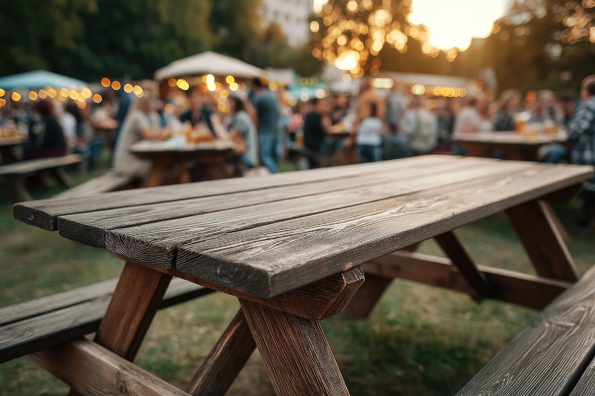 A,Rustic,Wooden,Picnic,Table,Sits,In,The,Foreground,,Sharply